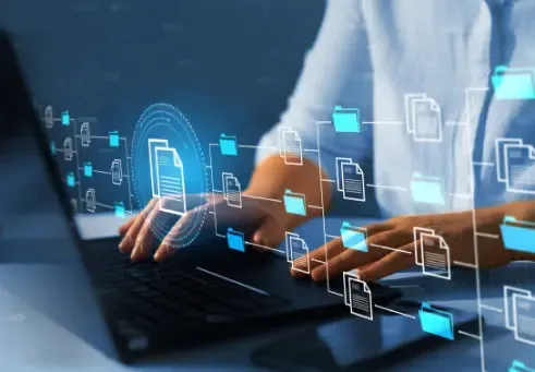 Woman working on a laptop with a file icon on the screen, representing cloud-based business solutions for efficiency and agility